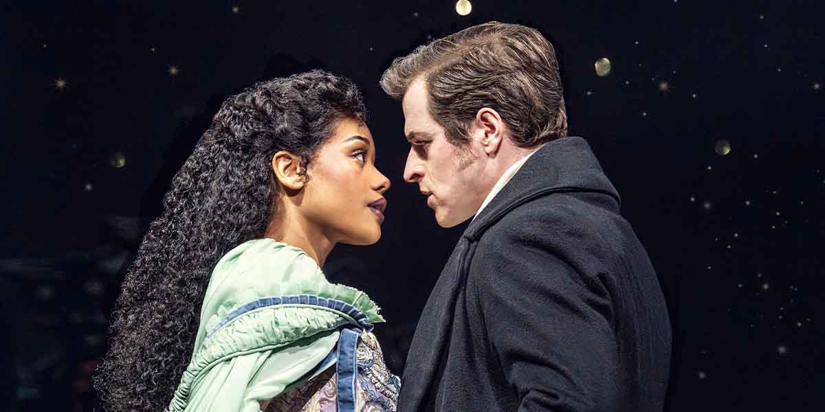 Beatrice Penny-Touré and Ashley Gilmour face each other, with dramatic expressions against a starry background.