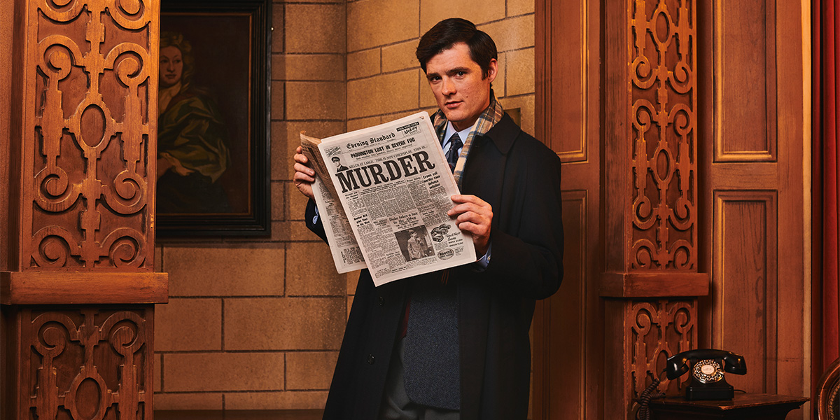 A scene from The Mousetrap featuring actors in period costumes on stage, with dramatic lighting and a wooden set.