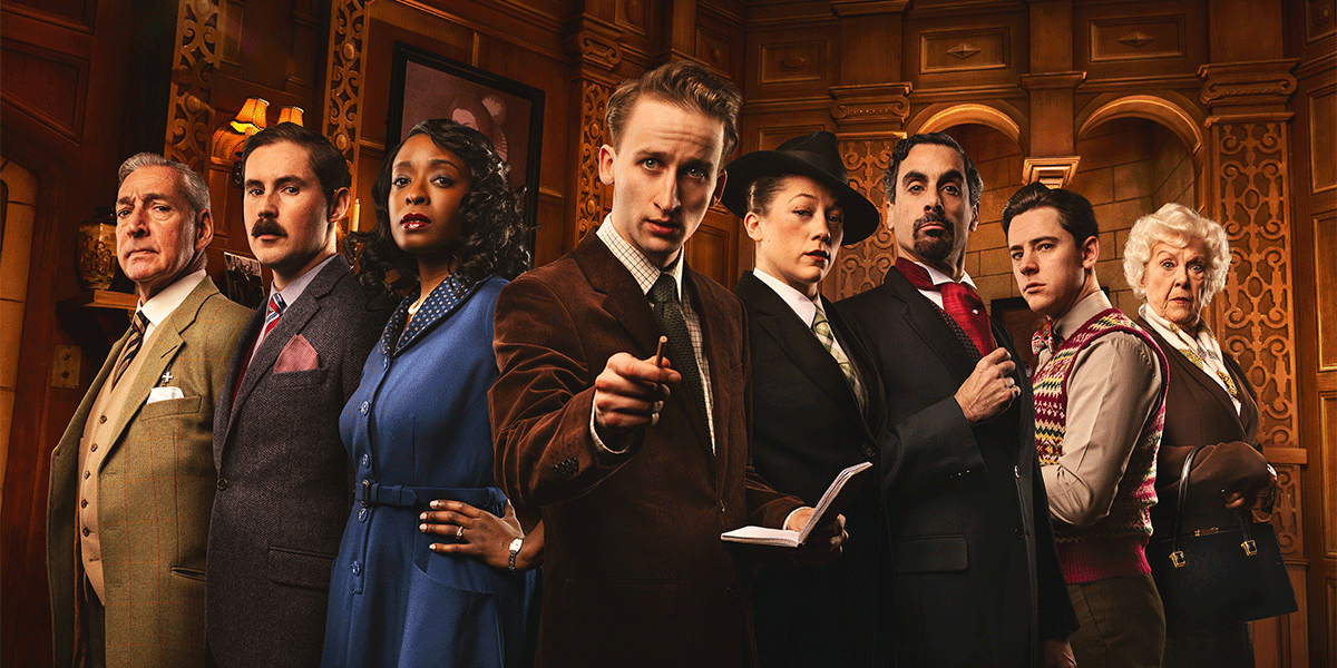 Eight characters stand in a wooden, warmly lit interior, dressed in vintage attire, displaying various expressions.