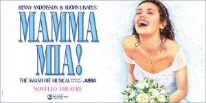 A vibrant scene from Mamma Mia! featuring characters in colourful costumes, dancing joyfully on stage.