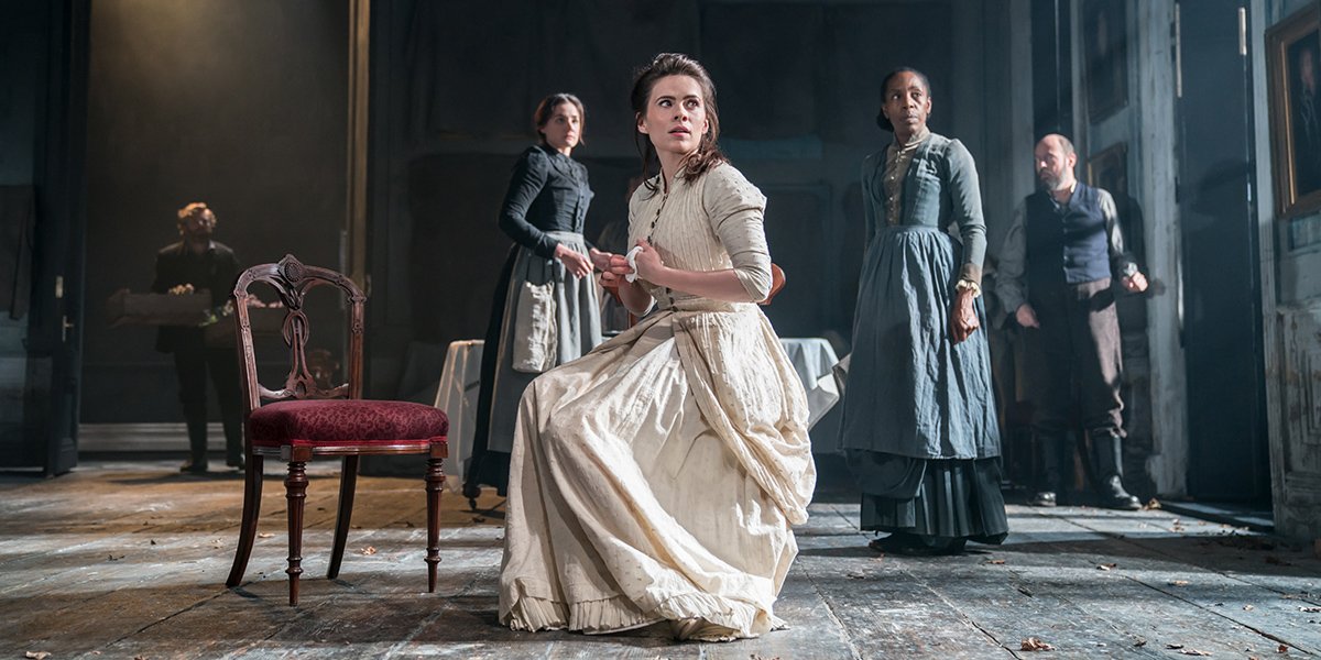 Exterior view of the Malmaison Hotel in Aberdeen with a traditional stone building and a patio area. Interior view of a modern bedroom with a vibrant yellow upholstered headboard and white bedding.