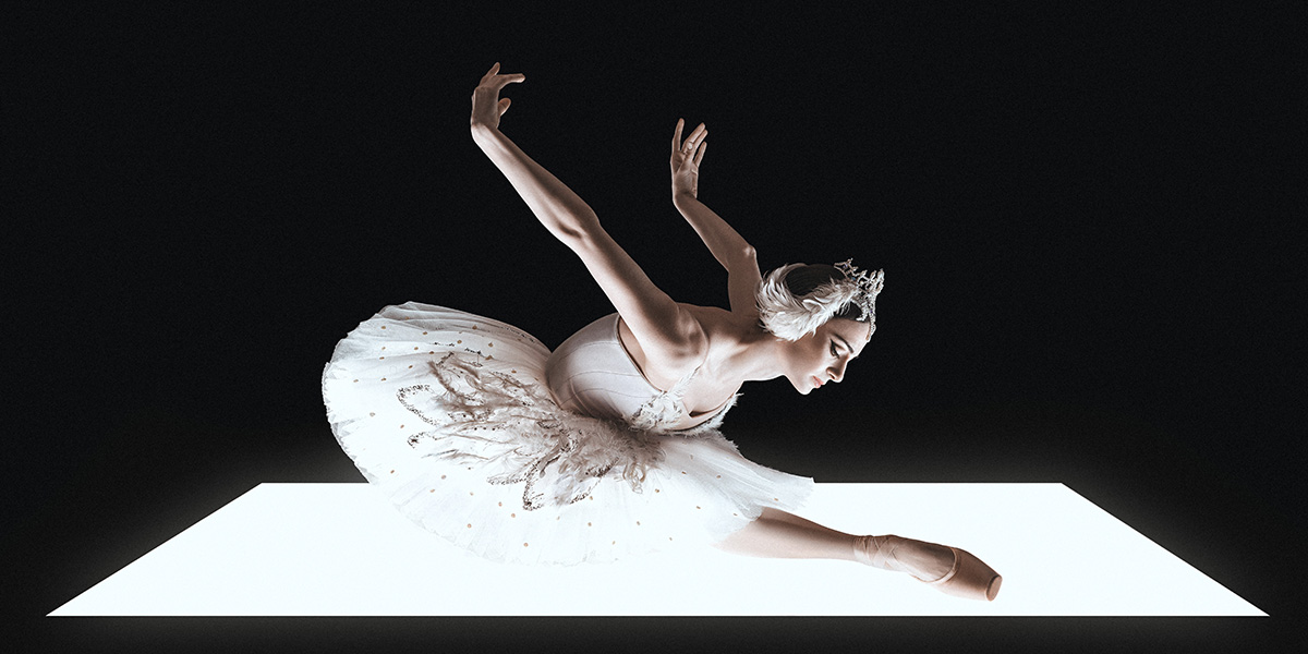 A ballet dancer in a white tutu performs an elegant pose on a bright rectangular platform.