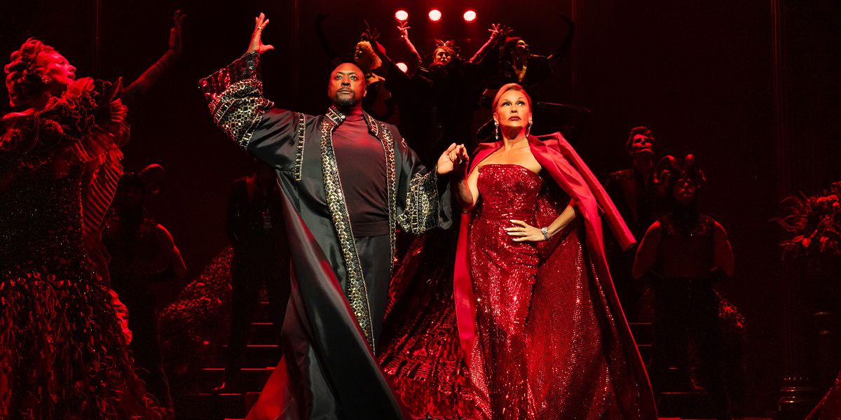 Matt Henry and Vanessa Williams pose together, both in stylish outfits, against a neutral background.