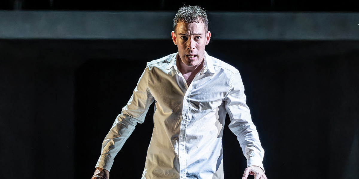 David Shields as Jacob Dunne, wearing a dark suit, seated with a serious expression against a blurred background.