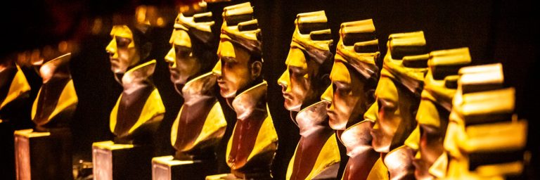 A row of large Olivier Award statue