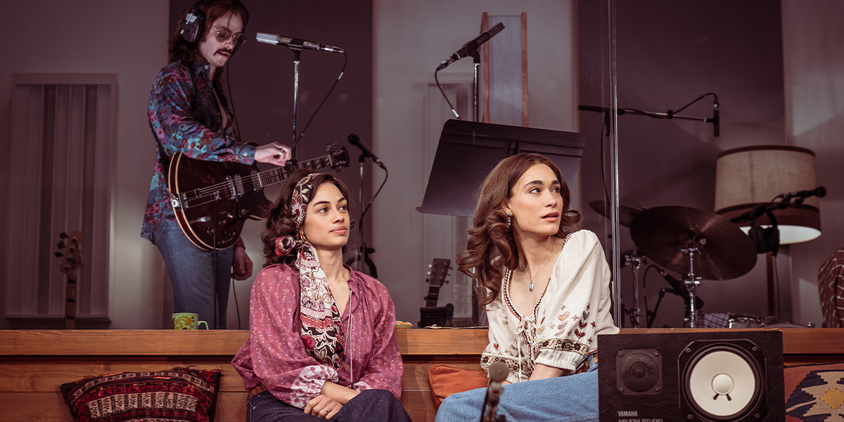 Nia Towle and Lucy Karczewski stand side by side, while Jack Riddiford is positioned above them.