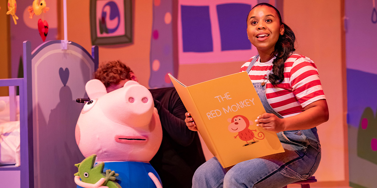 George and Daisy, dressed in colourful costumes, pose together on stage during Peppa Pig's Big Family Show.