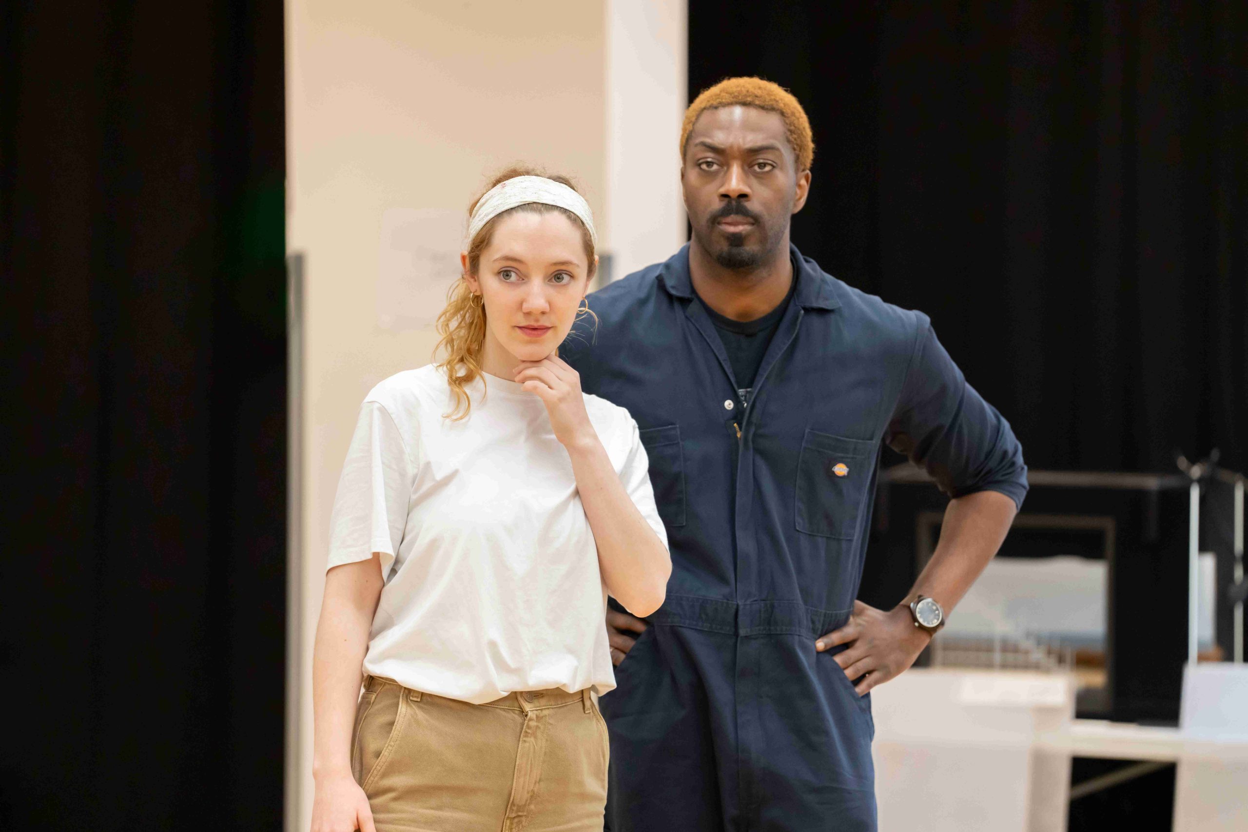 Mirren Mack and David Ajala in rehearsal for My Master Builder. Mirren is wearing a white t-shirt and David is wearing a blue jumpsuit