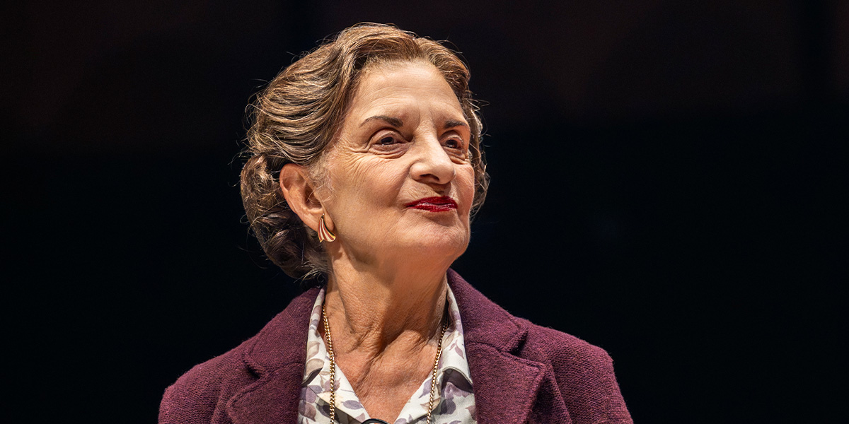 Norma Atallah performing on stage in a dramatic scene from The Spy Who Came in From the Cold.