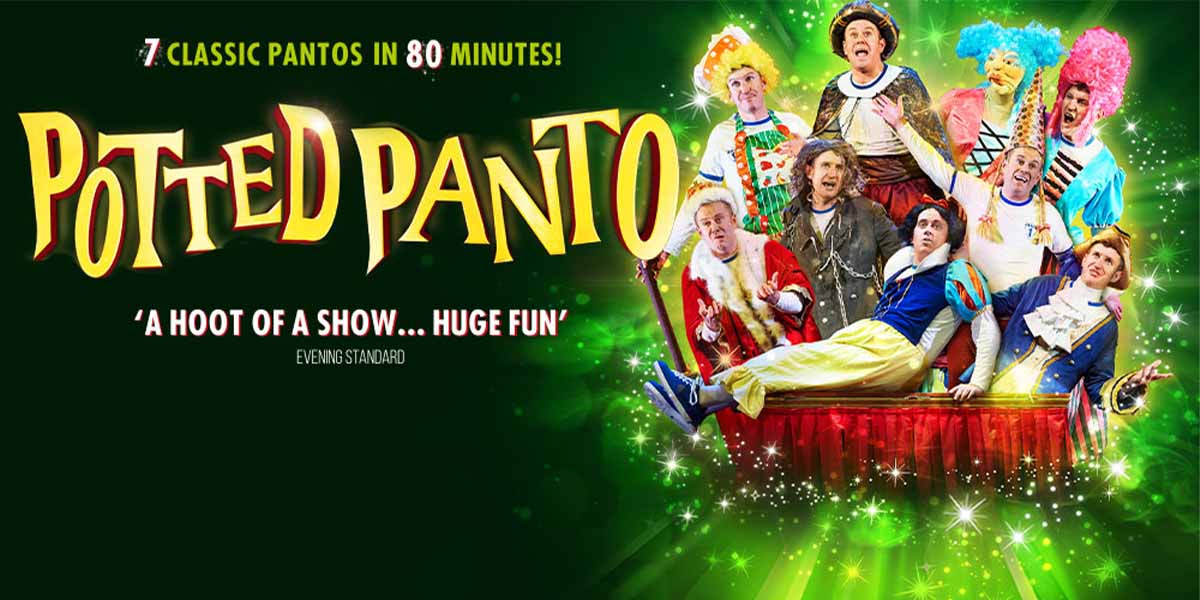 A festive stage scene featuring colourful decorations, with actors in costume performing a lively scene from a panto.