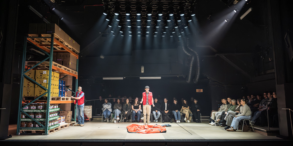 A group of people seated at a table, engaged in discussion, surrounded by warm lighting and wooden decor.