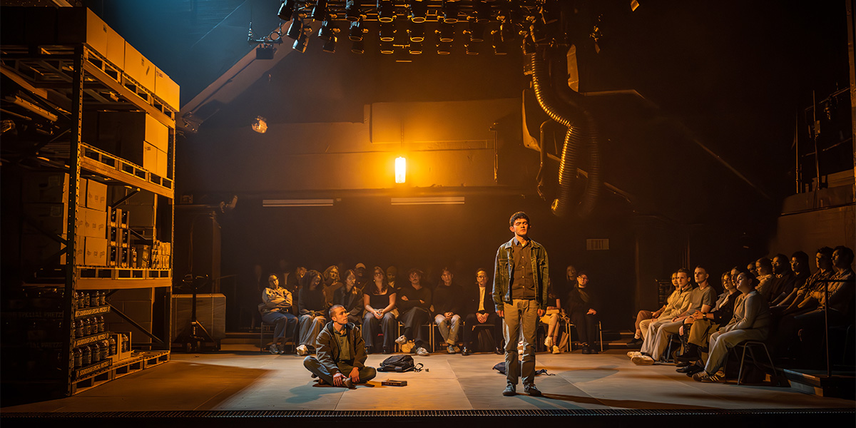 A group of people in formal attire are seated at a round table, engaged in discussion.