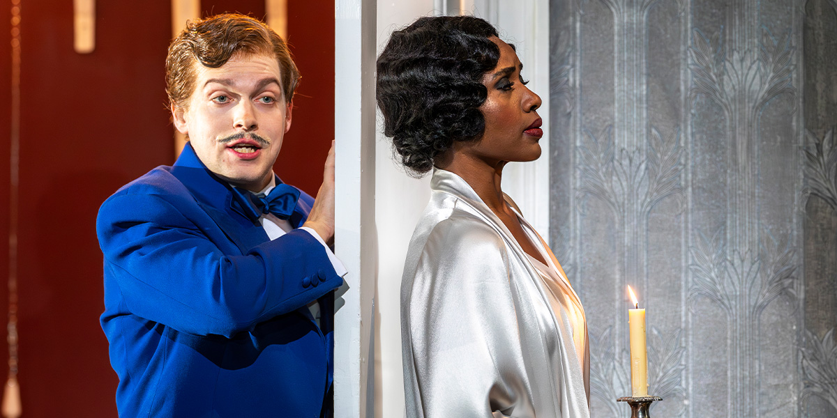 Hugh Cutting and Nardus Williams perform in ENO's Partenope 2025, dressed in elaborate costumes on stage.