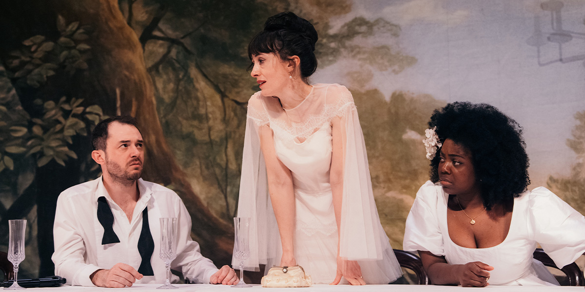 A scene from "A Midsummer Night's Dream" featuring actors in elaborate costumes, surrounded by greenery.