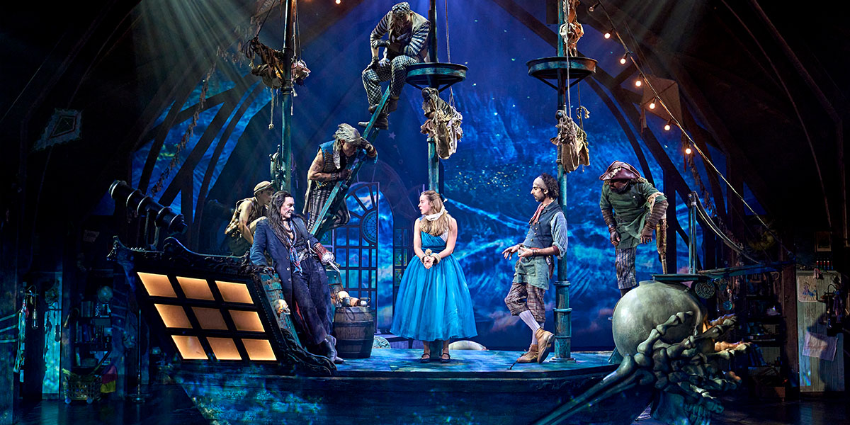 Wendy and Peter Pan are flying together against a starry night sky, surrounded by soft clouds.