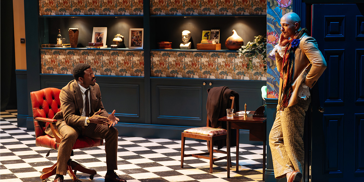 Chiké Okonkwo and Jamael Westman pose together, smiling, in formal attire against a neutral background.