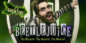 A vibrant stage scene from Beetlejuice The Musical, featuring colourful costumes and dramatic lighting.