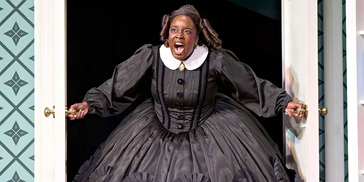 Lolly Adefope, portraying Mary Todd Lincoln, passionately gestures from an open door, wearing a black gown.