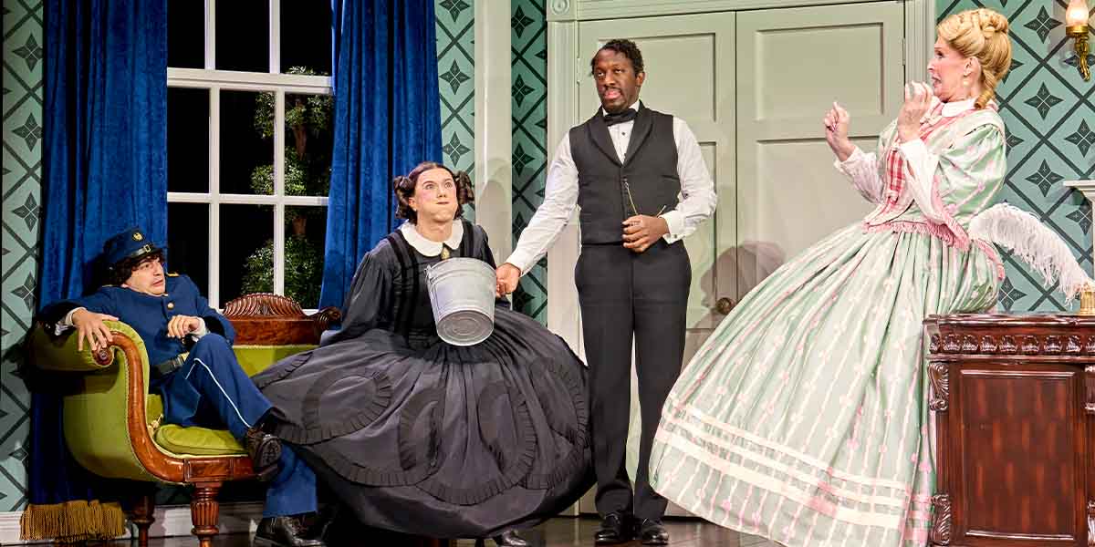 Tony Macht, Cole Escola, Giles Terera, and Bianca Leigh perform in a theatrical scene with vibrant costumes.