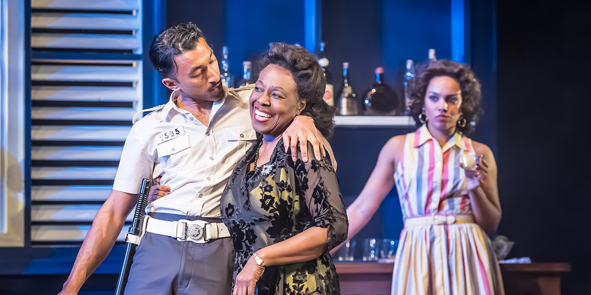 Shane David-Joseph, Ellen Thomas, and Cat White pose together, smiling, in a theatre setting.