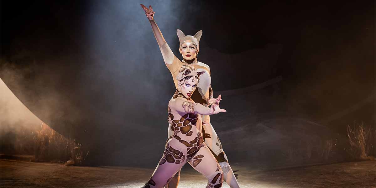 Millie O'Connell as Demeter and Katie Dunsden as Bombalurina pose dramatically against a smoky backdrop.