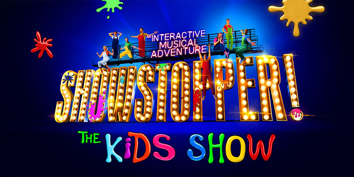 A vibrant stage scene from "Showstopper! The Christmas Kids Show" featuring colourful decorations and performers.
