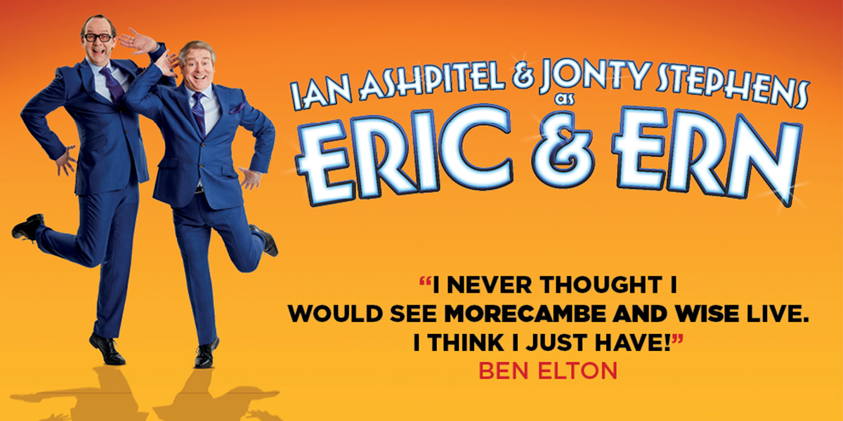 Two people in blue suits stand against an orange background. In the centre it reads Eric & Ern
