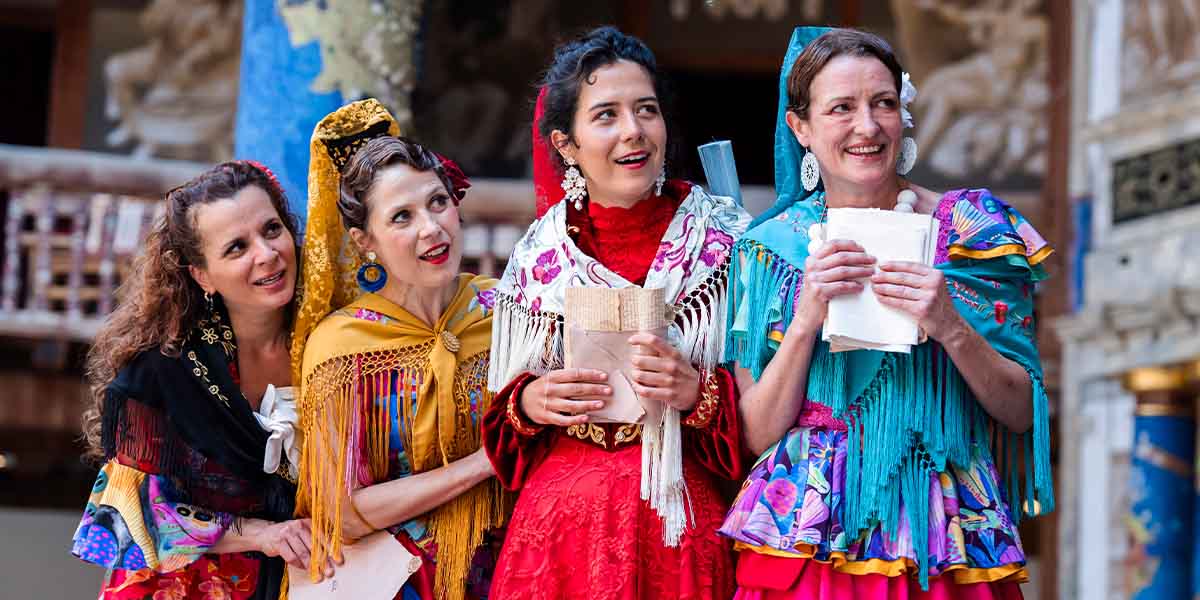 A vibrant outdoor theatre scene at Shakespeare's Globe, featuring actors in period costumes performing a scene from Love's Labour's Lost.