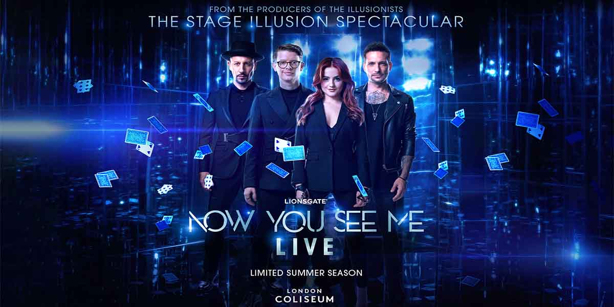 Four performers stand together, surrounded by floating playing cards, against a blue, illuminated background.