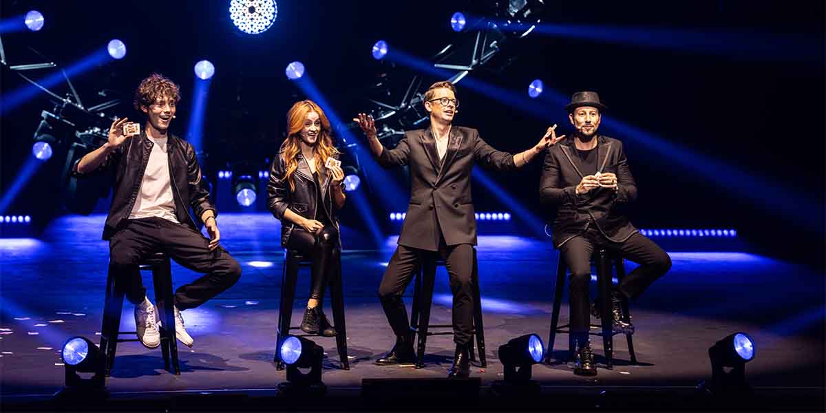 Rafferty Coope, Gabriella Lester, Matthew Pomeroy, and Andrew Basso perform on stage in NOW YOU SEE ME LIVE.