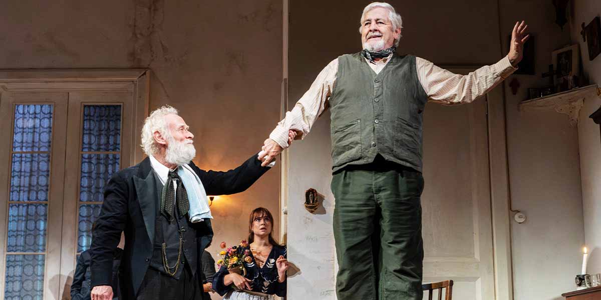 Karl Johnson and Peter Wight perform in "The Cherry Orchard," with a woman in the background.