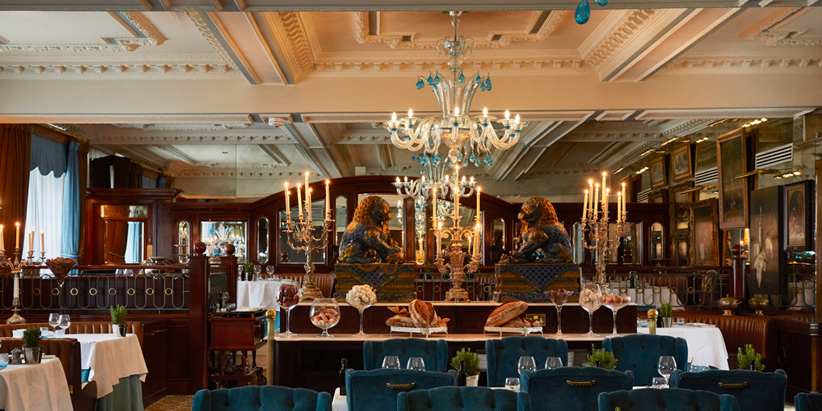A beautifully set dining table at The English Grill, featuring elegant tableware and a floral centrepiece.