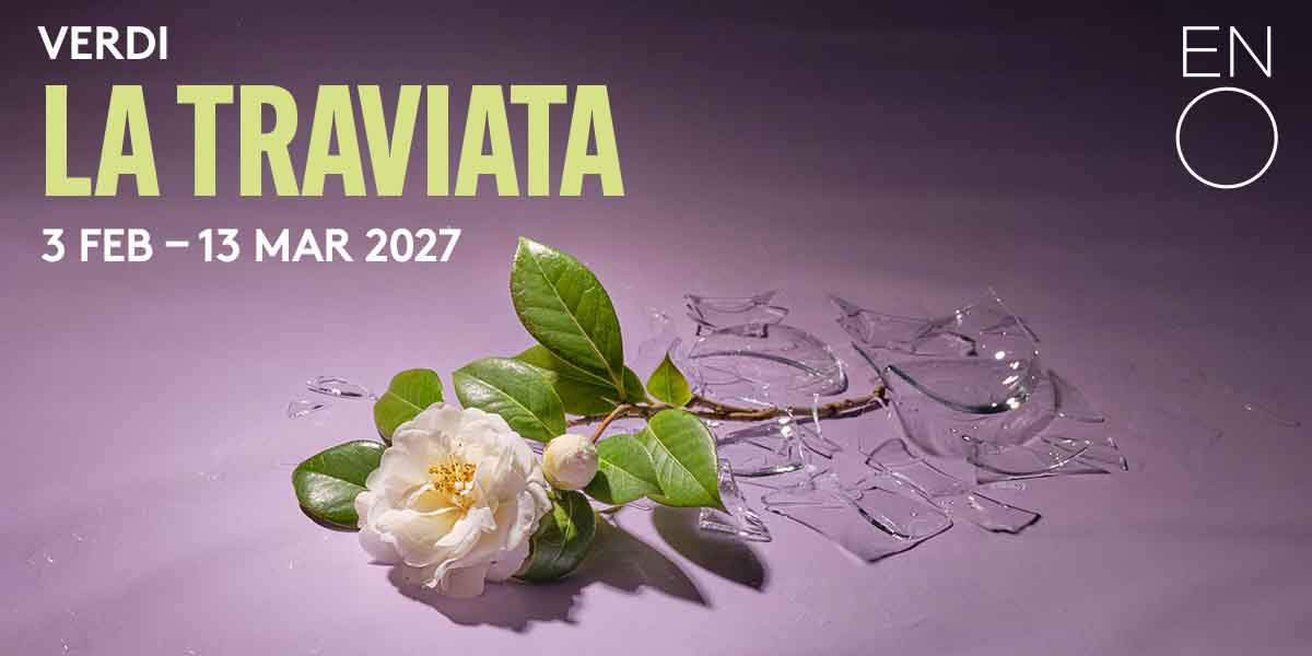 A white camellia flower with green leaves rests among shattered glass on a purple background.