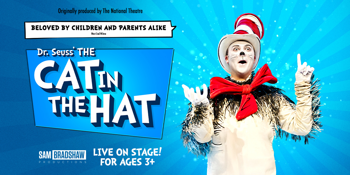 A person in a Cat in the Hat costume stands among children, who are smiling and engaged.