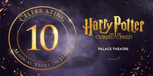 A stage scene from "Harry Potter and the Cursed Child," featuring characters in wizarding attire with magical props.
