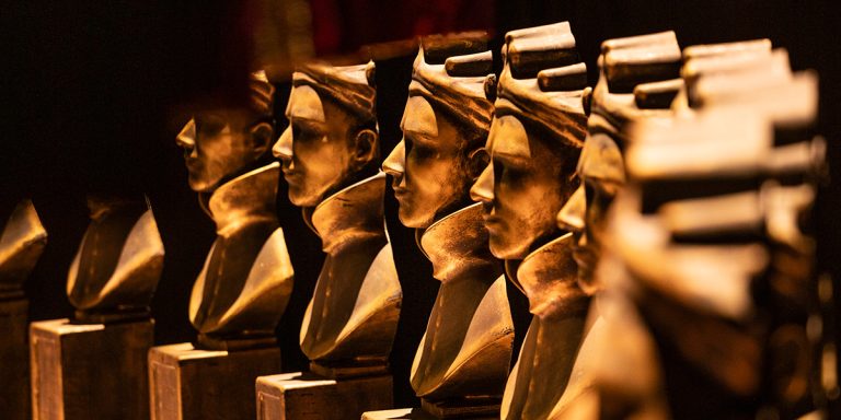 Olivier Award statues displayed at the Olivier Awards 2026 event, featuring gold finishes.