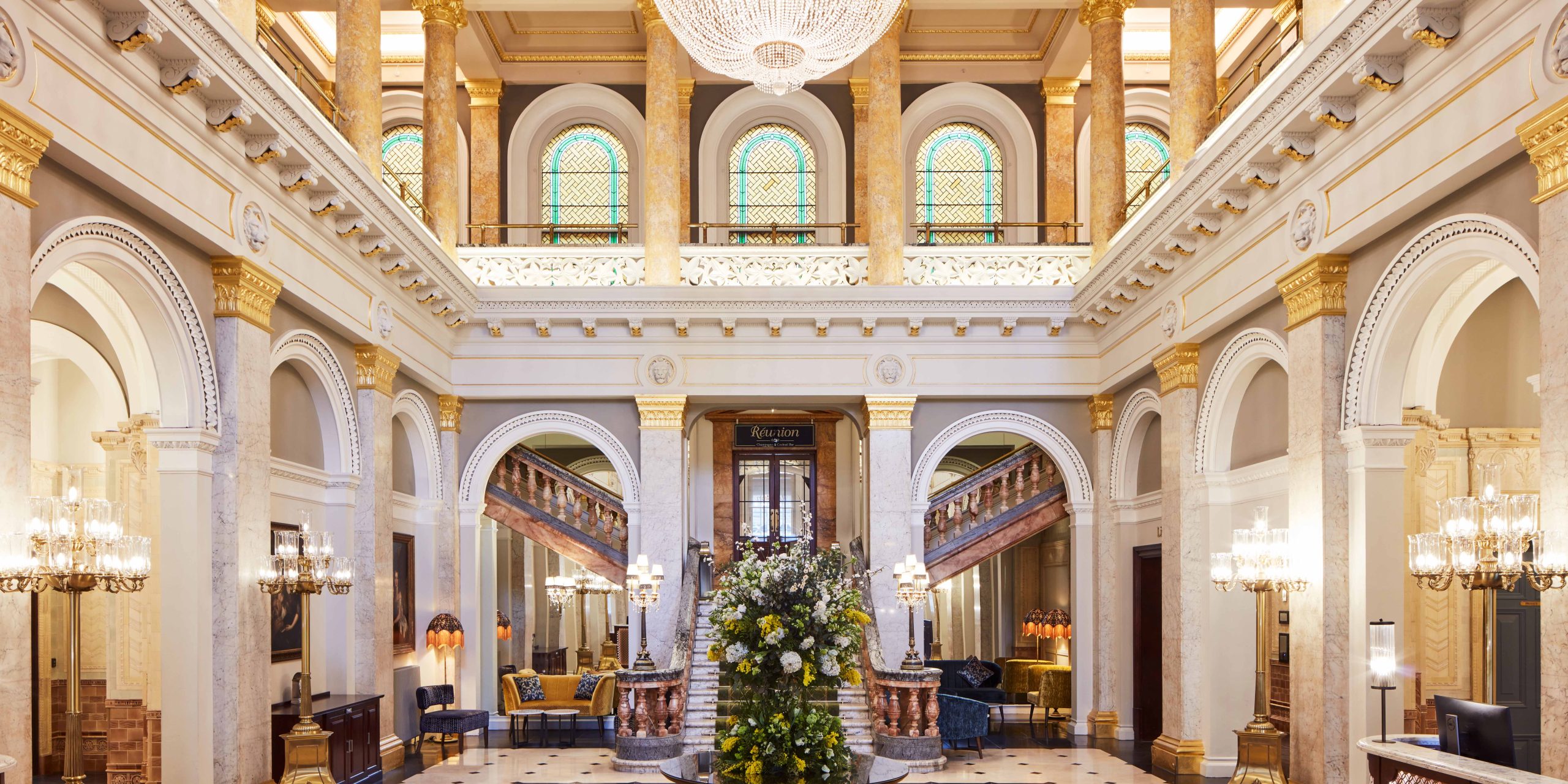 The Victoria Lobby features elegant decor with plush seating, large windows, and a welcoming reception area.